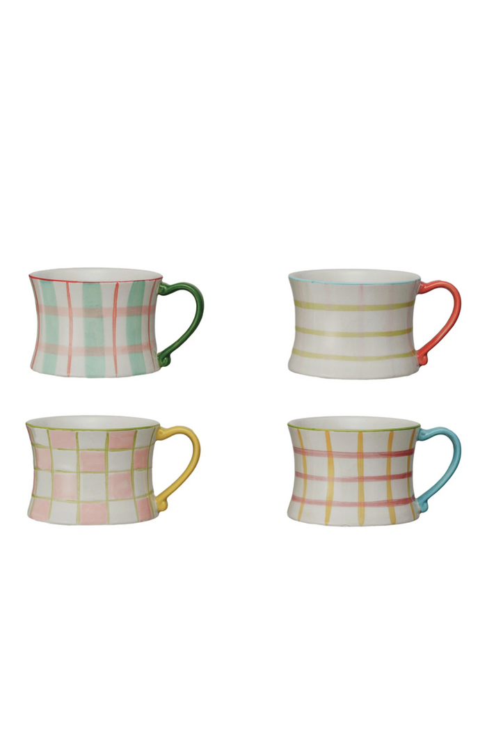 Four colorful mugs with plaid patterns on a white background