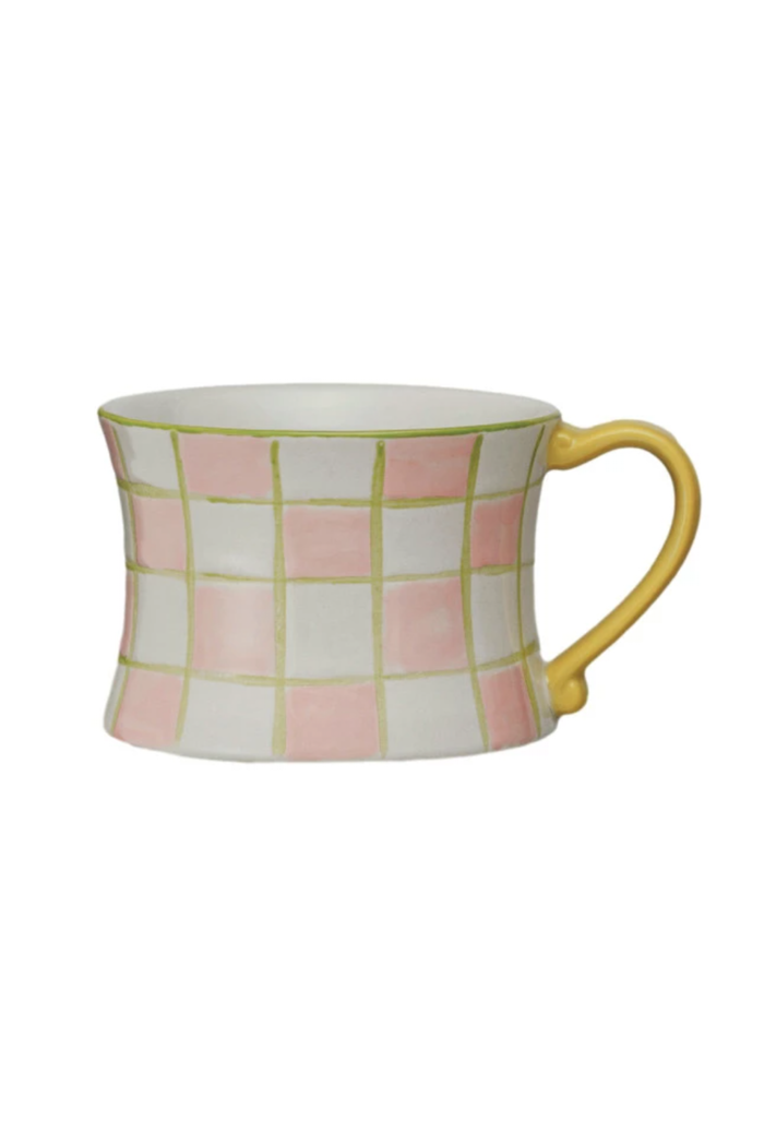 A set of four hand-painted stoneware mugs with various patterns and colored handles.