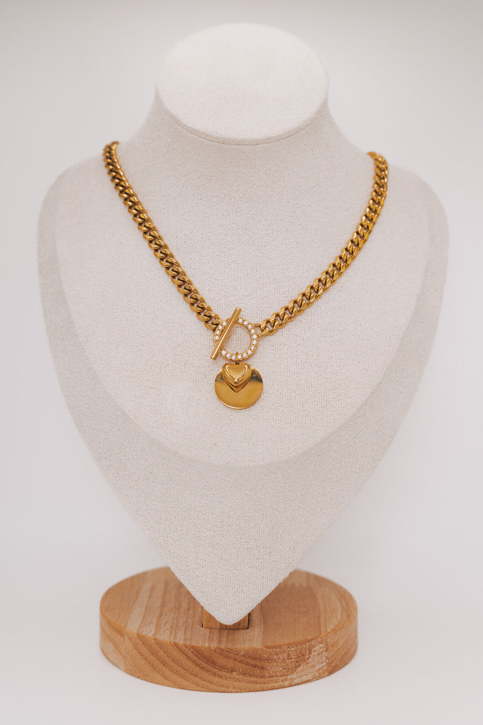 thick gold chain with stone accents and heart pendant