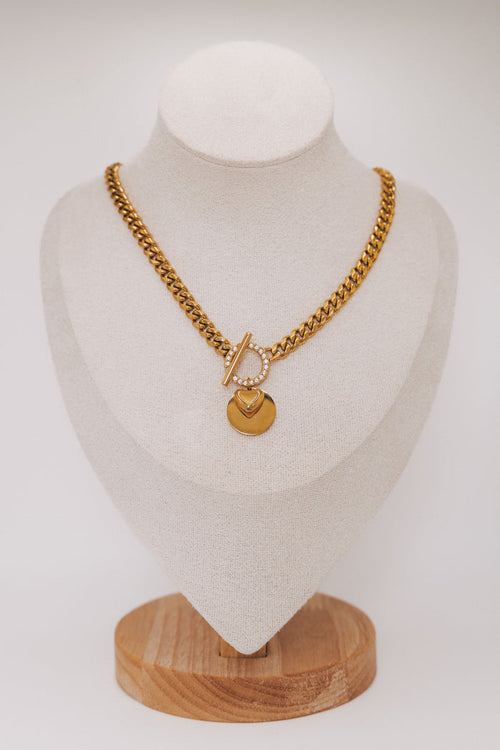 thick gold chain with stone accents and heart pendant
