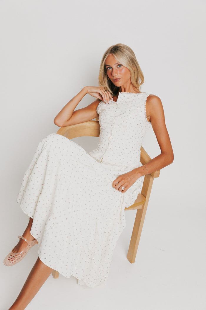 off white button down sleeveless top with floral pattern and lace trim