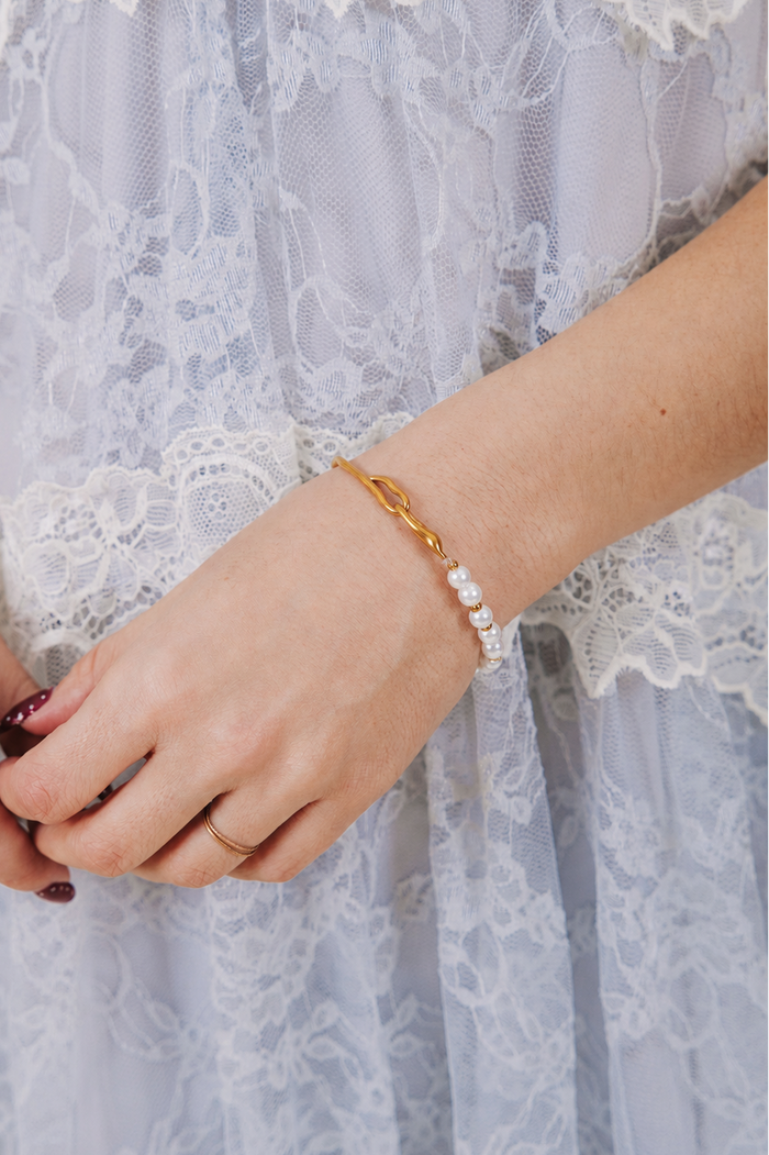 Asymmetrical bracelet with half gold and half pearl with gold bead accents