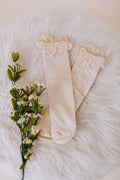 beige baby sock with eyelet lace trim and ribbed material