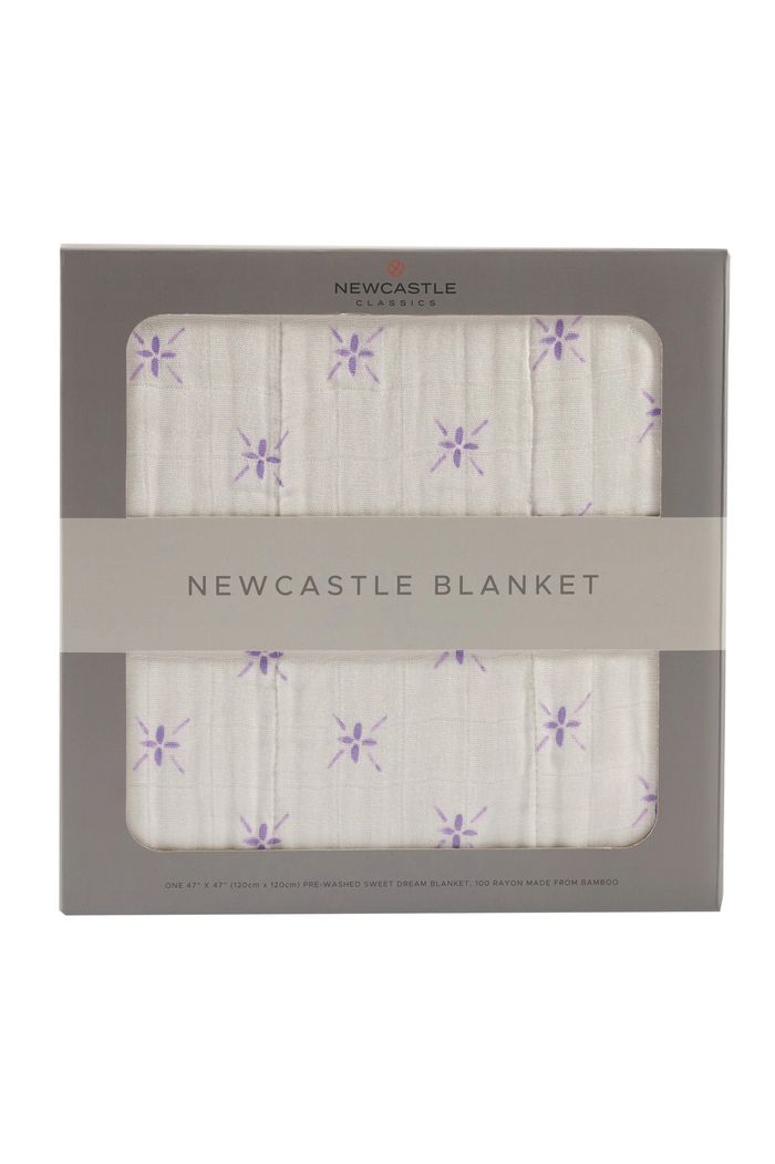 Newcastle blanket with purple flower pattern in packaging on a white background