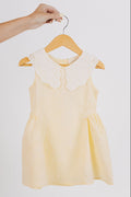 yellow baby dress with white eyelet collar
