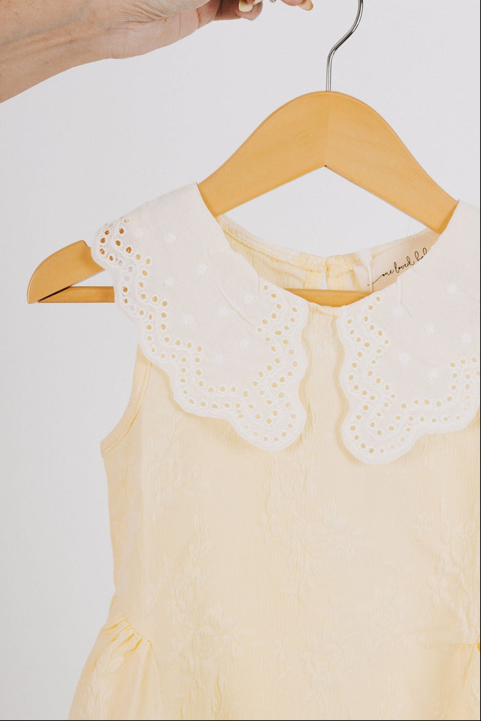 yellow baby dress with white eyelet collar