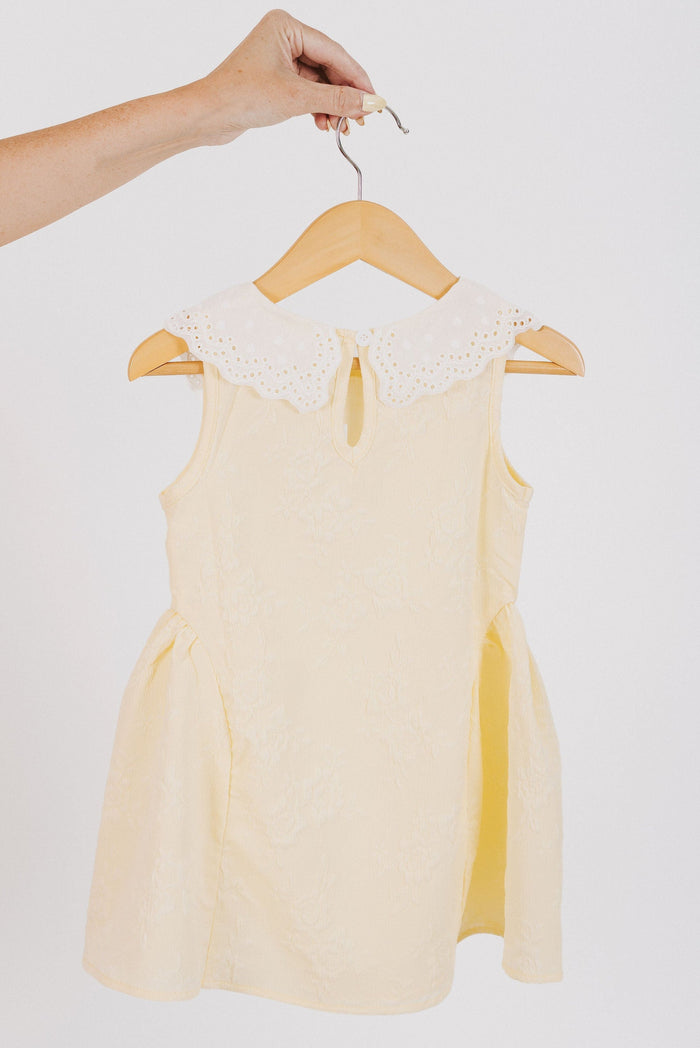yellow baby dress with white eyelet collar