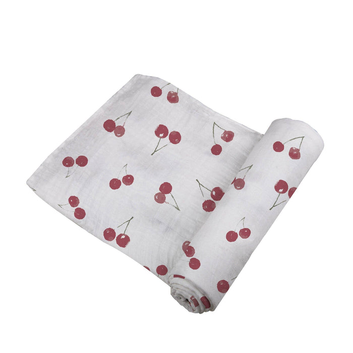 white baby swaddle with cherry pattern by newcastle classics