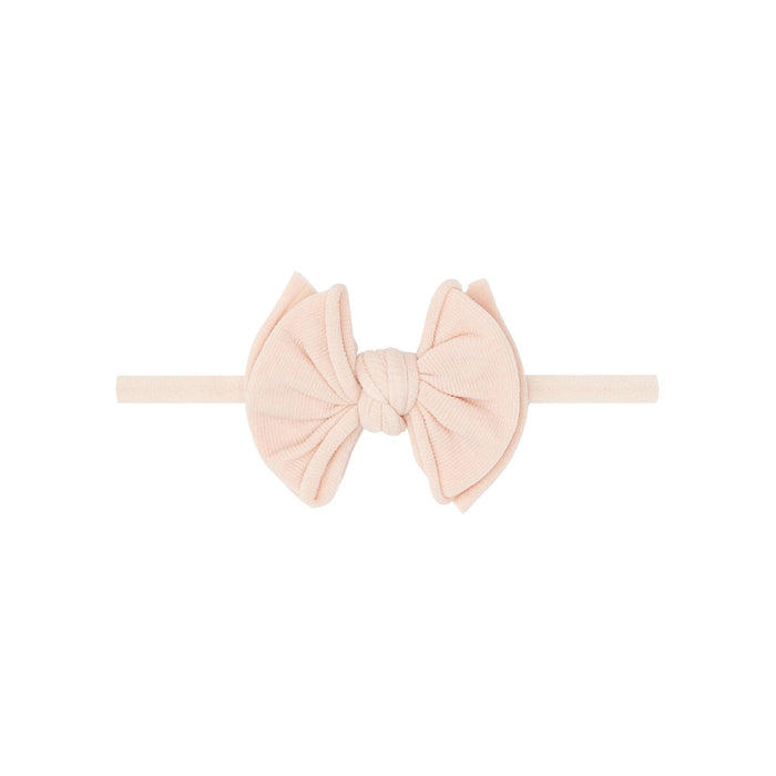 Blush pink headband with a bow on a white background
