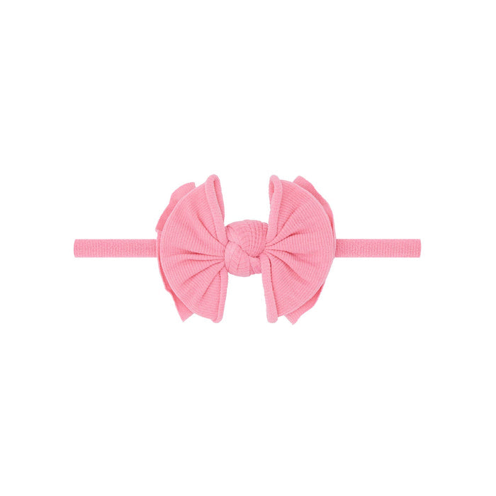 Pink headband with a large bow on a white background