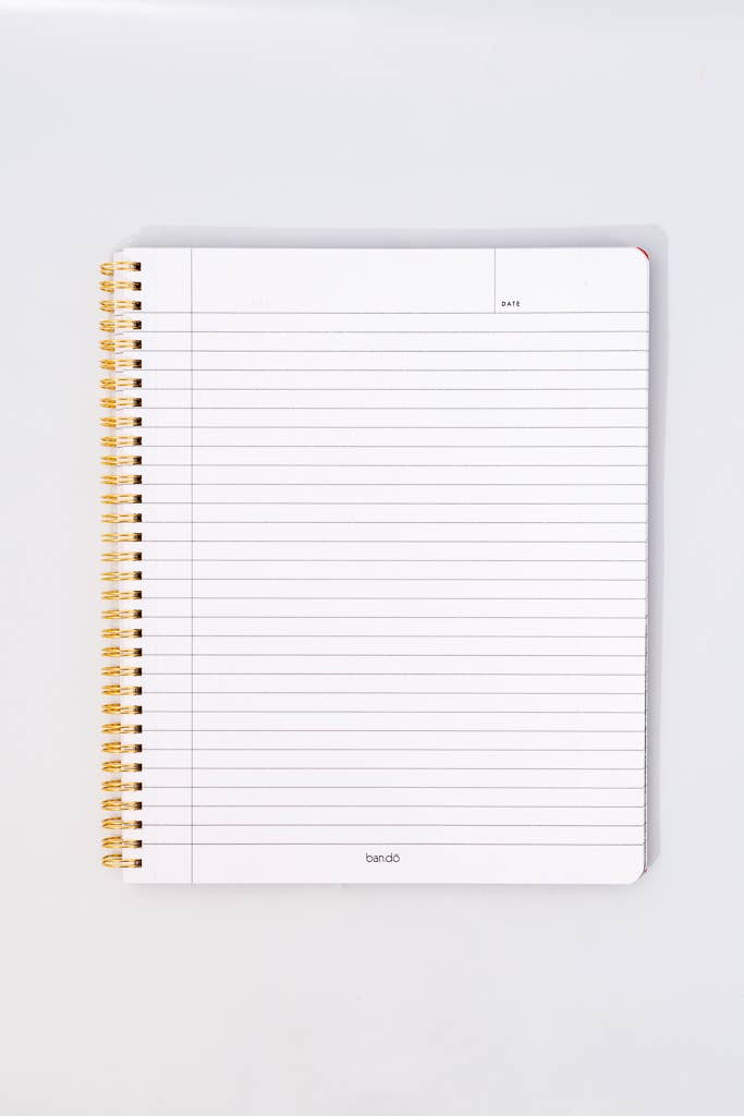Notebook with spiral binding on a white background lined paper date