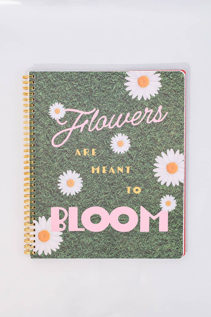 Notebook with floral design and text on a white background gold spiral bound surprise page flowers are meant to bloom