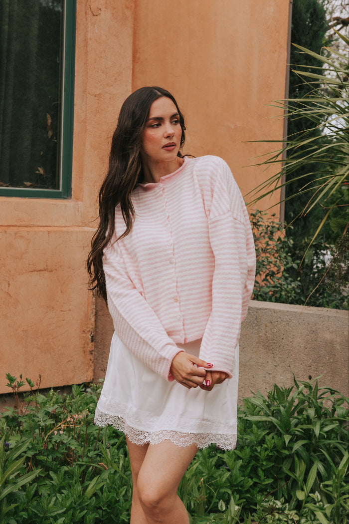 Off white and pink striped sweater with a button down front. Super soft material with rolled edges, long sleeves, and drop shoulders.