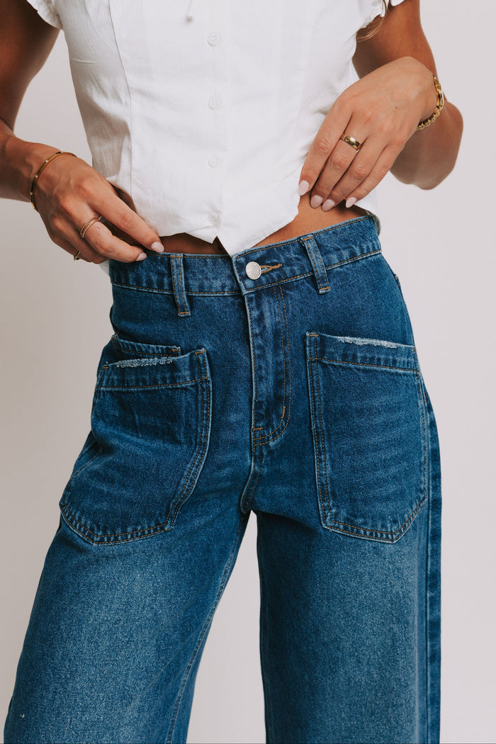 dark wash denim jeans with oversized front pockets close