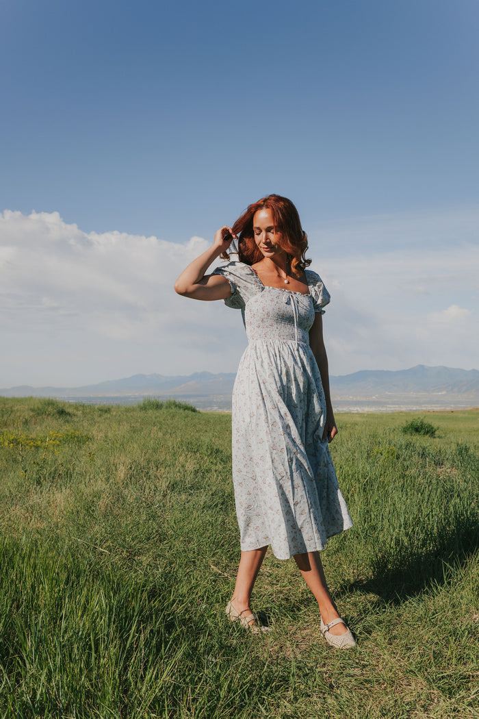 Light blue dress with puff sleeves midi length shirred bodice