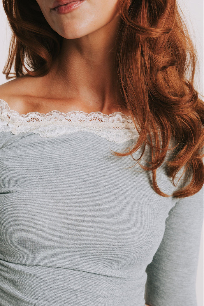 grey long sleeve top with lace trim on the neckline close
