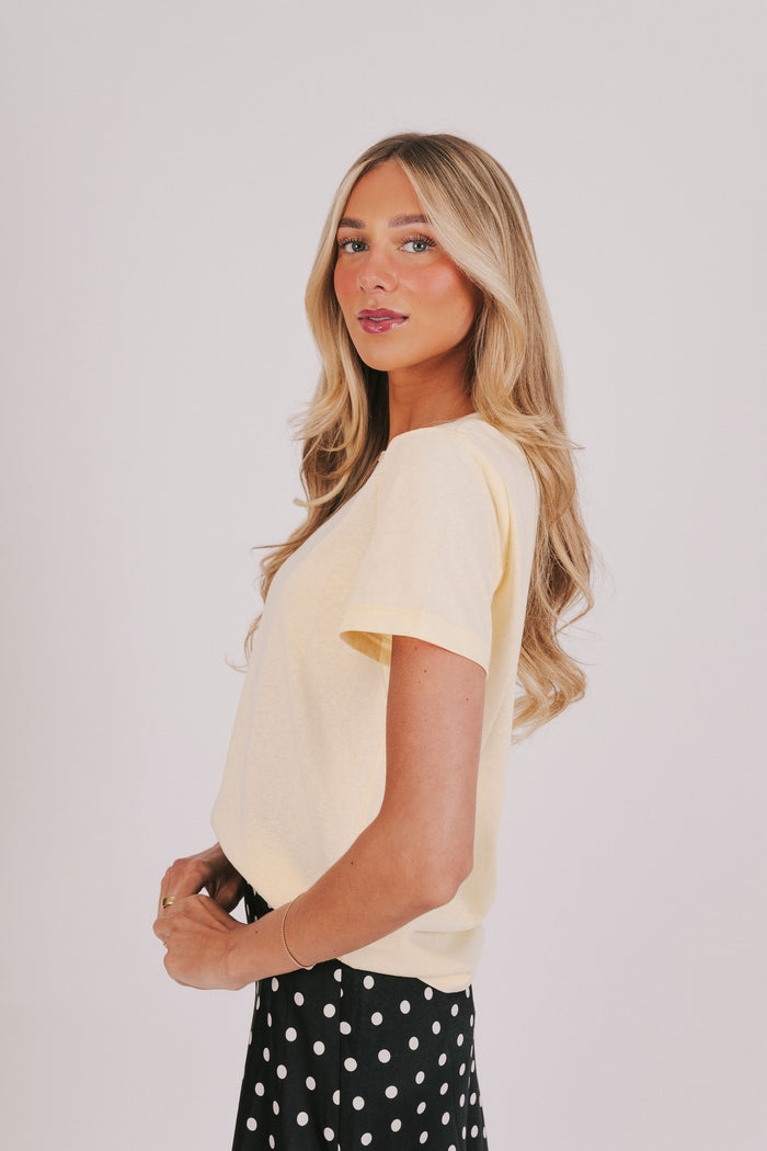 yellow short sleeve top with a round neckline
