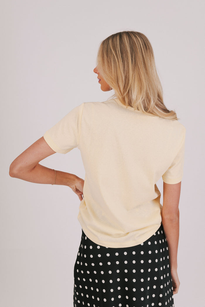 yellow short sleeve top with a round neckline