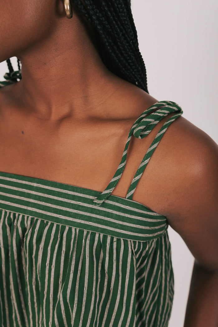 green and tan striped top with thin straps detail shot