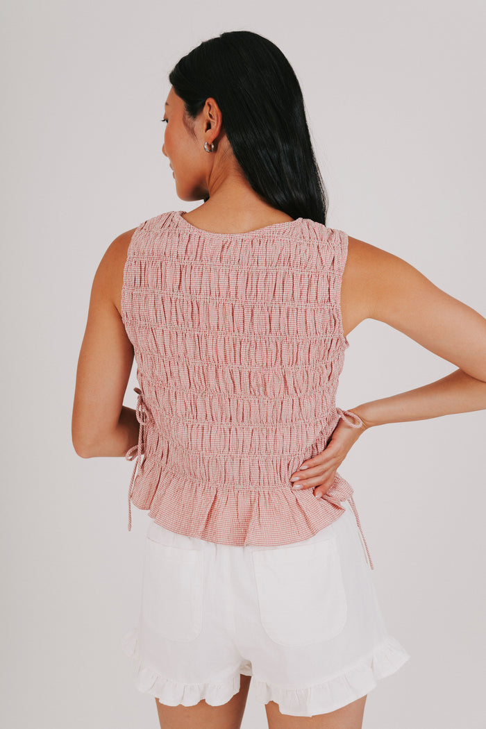 red smocked tank with bows on the side back