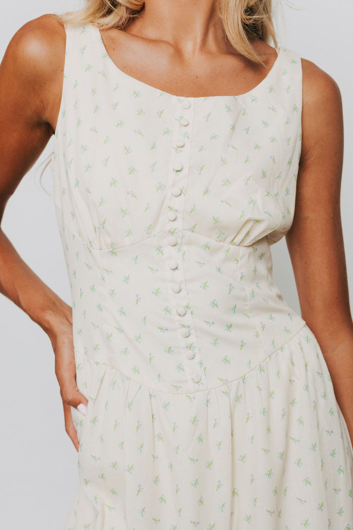 butter yellow midi dress with floral pattern and button down bodice