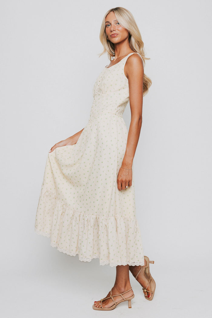 butter yellow midi dress with floral pattern and button down bodice side