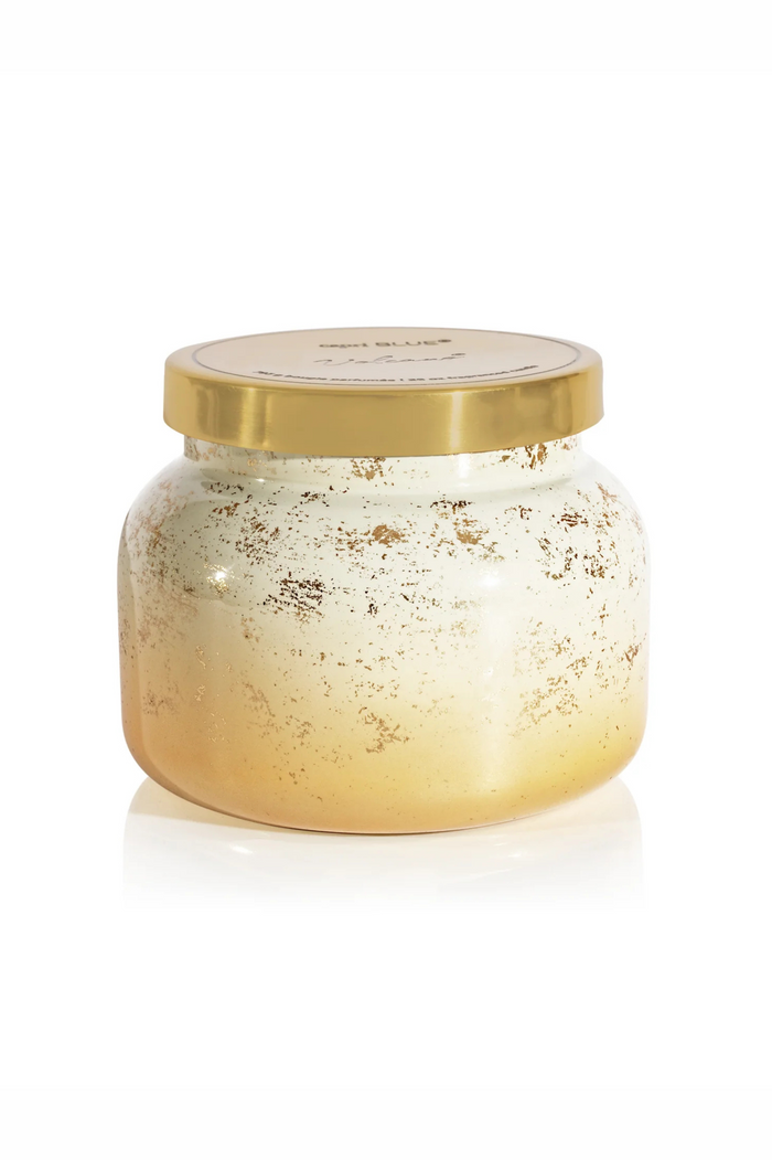 White to gold brushed gradient candle with gold lid in volcano by capri blue.