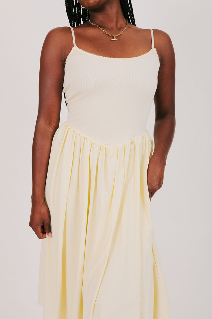 yellow spaghetti strap dress with flowy skirt