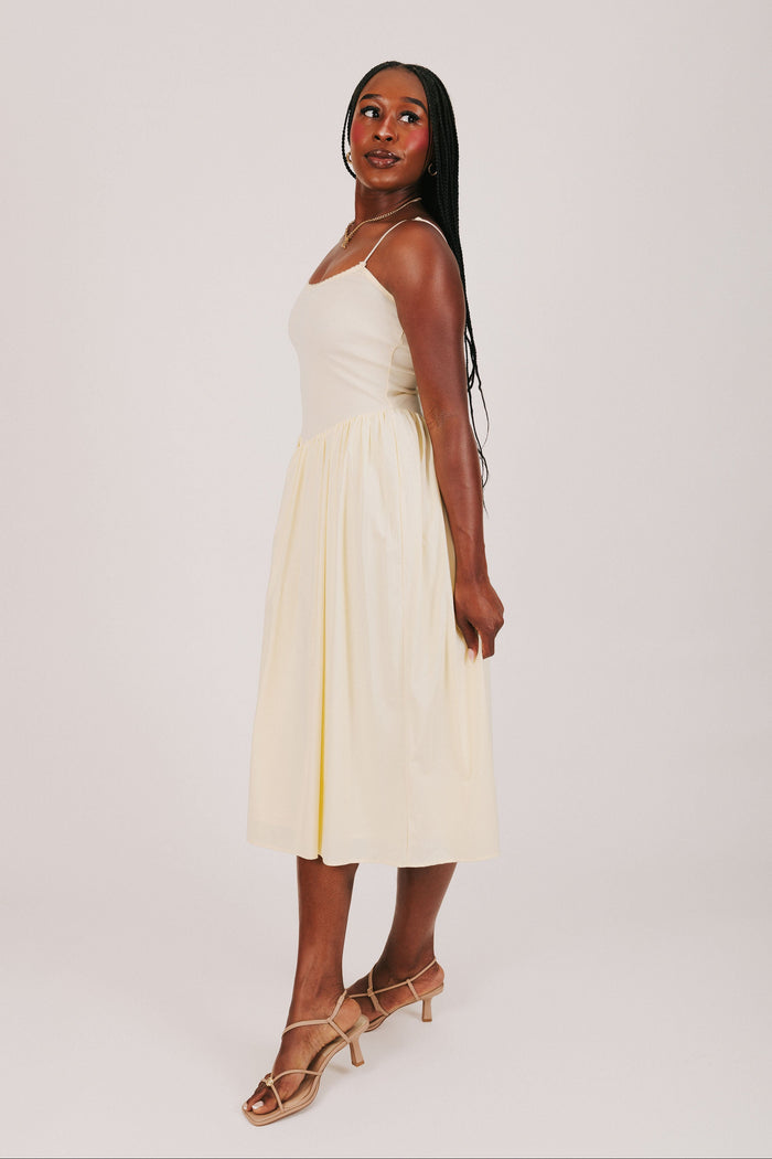 yellow spaghetti strap dress with flowy skirt