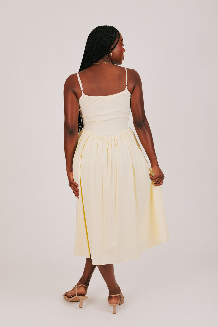 yellow spaghetti strap dress with flowy skirt back