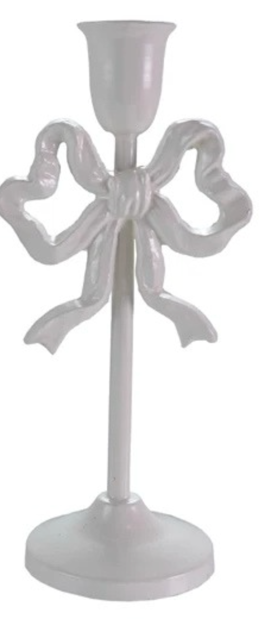 White ivory candle holder with bow design on a white background