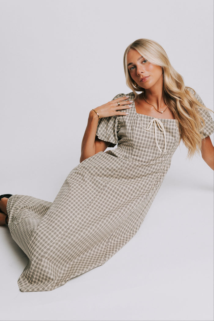 plaid basque waist dress with bow details pose