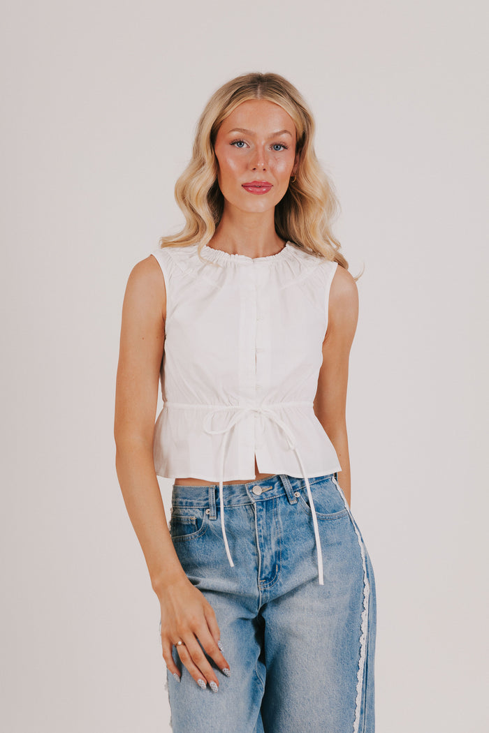 white sleeveless top with tie at the waist
