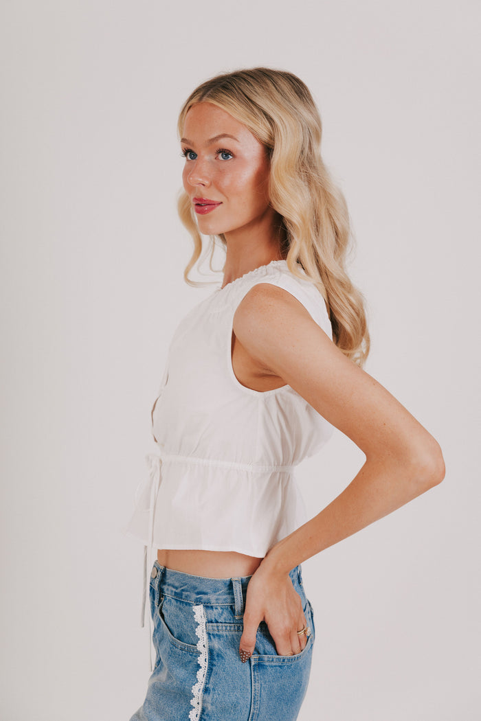 white sleeveless top with tie at the waist