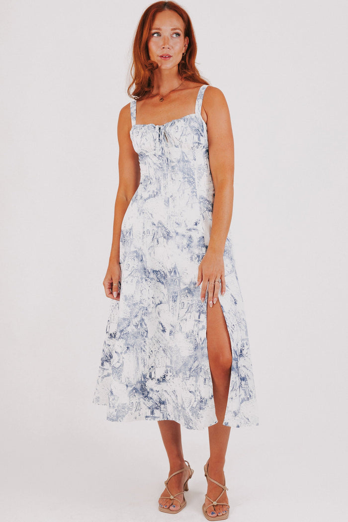 white dress with blue city print and structured bodice full