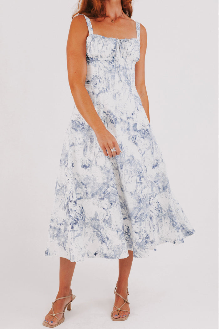 white dress with blue city print and structured bodice