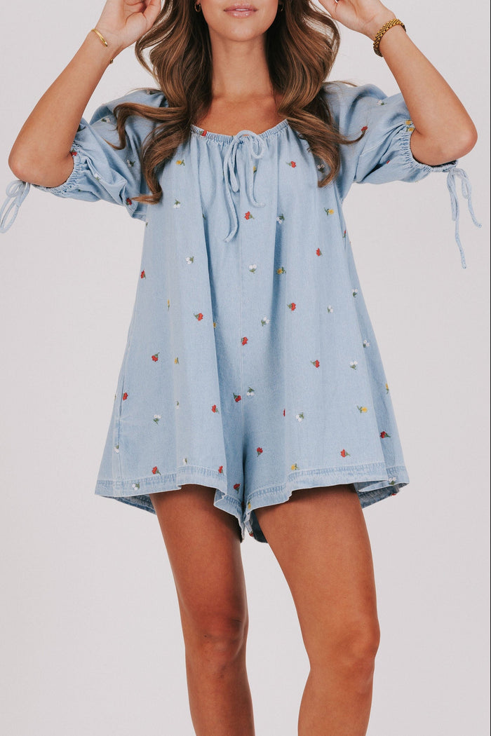 denim romper with embroidered flowers front