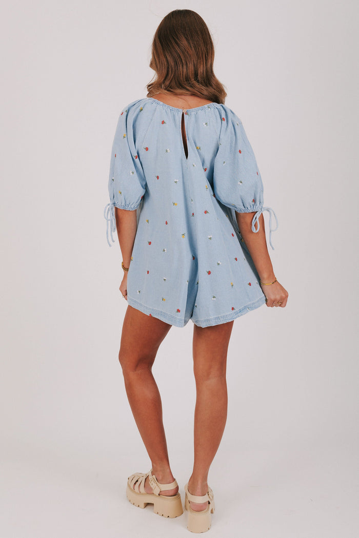 denim romper with embroidered flowers back