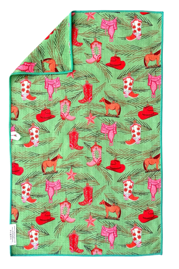 Green hand towel with cowboy boot, hat, and horse pattern
