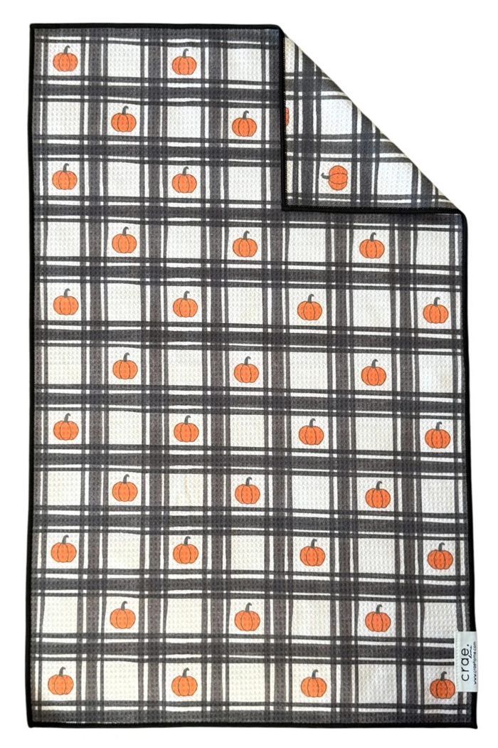Plaid microfiber hand towel with orange pumpkins on a white background