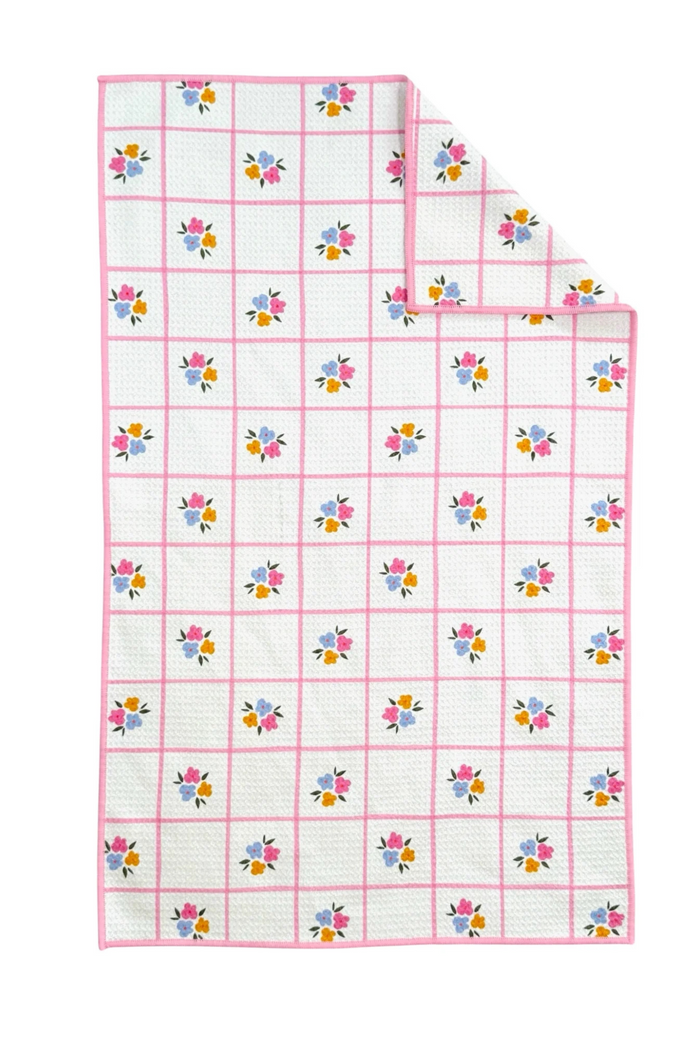 Floral patterned microfiber towel with pink border and a white background