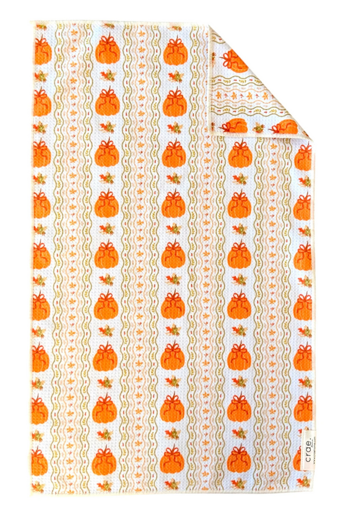 Microfiber hand towel with orange pumpkin pattern on a white background