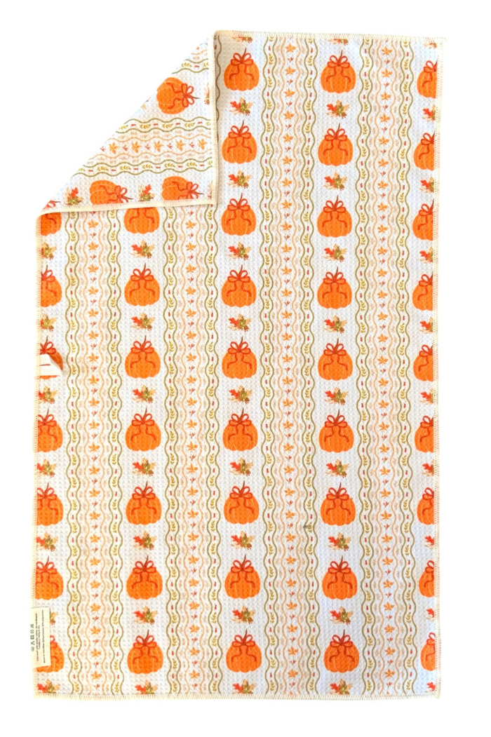 Microfiber hand towel with orange pumpkin pattern on a white background
