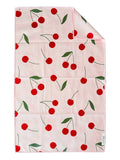 A pink double-sided microfiber hand towel with a cherry print and green leaves