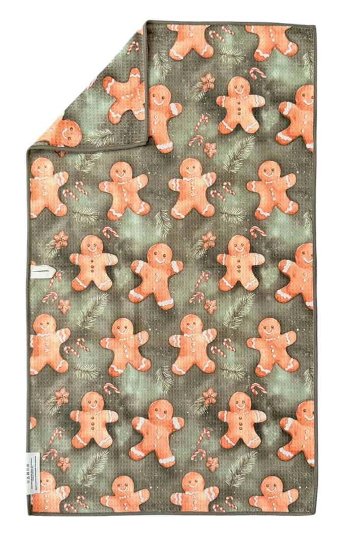 Microfiber hand towel with gingerbread man pattern on a green background.