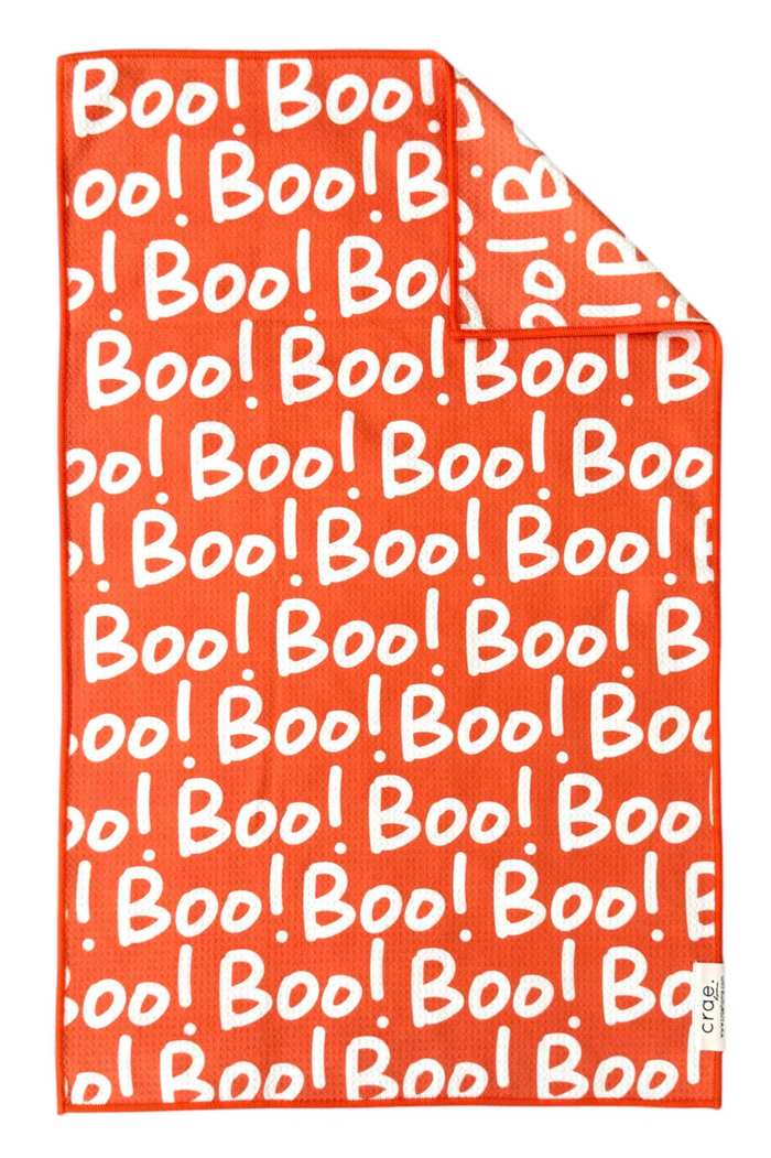 Orange microfiber hand towel with 'Boo!' pattern in white.