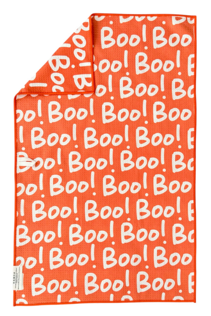 Orange microfiber hand towel with 'Boo!' text pattern in white.