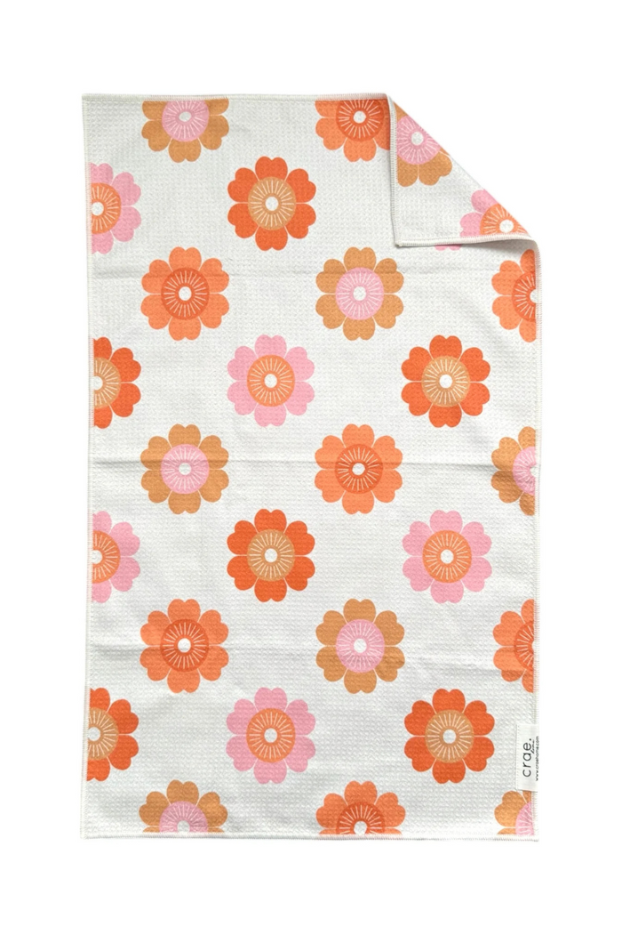 Floral patterned microfiber hand towel with orange and pink flowers on a white background