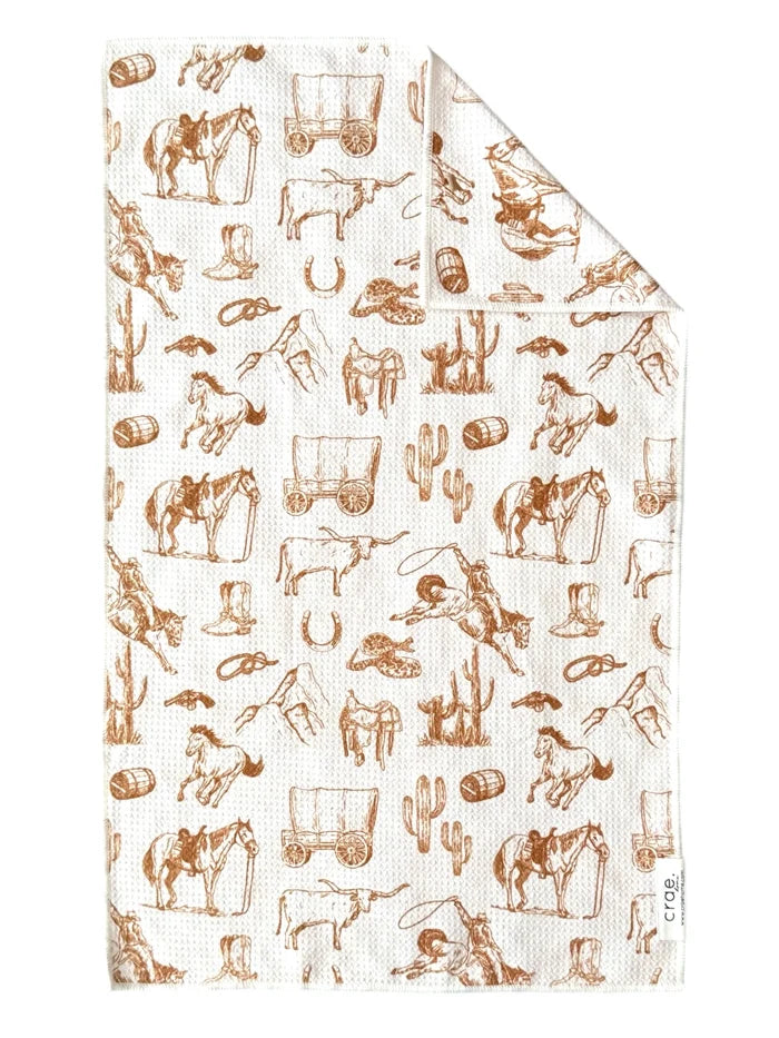 Patterned towel with cowboy-themed illustrations on a white background