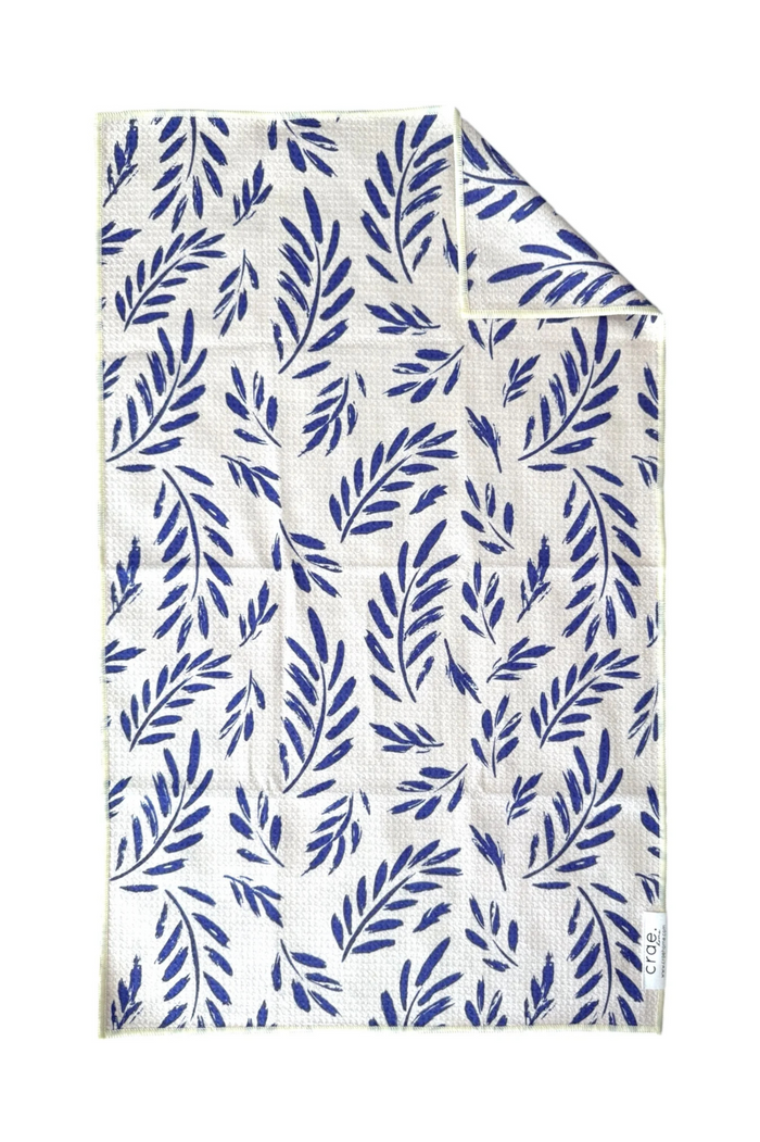 Microfiber hand towel with blue leaf pattern on white background
